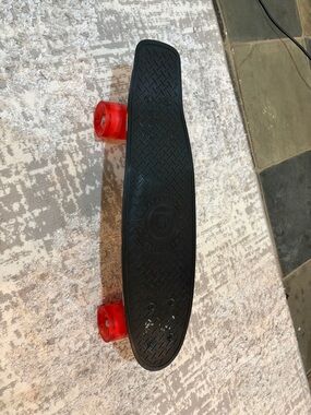 Kids Black Plastic Cruiser Skateboard with Red Transparent Wheels. Mad Gear